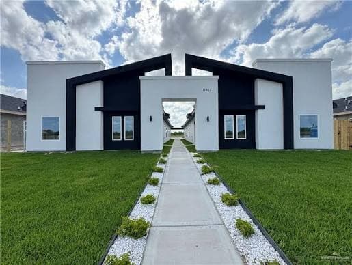 A newly built, gated fourplex development in McAllen with a modern black-and-white facade